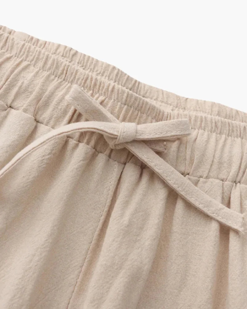 Beige linen trousers by Ilynora, fabric detail highlighting breathable material and natural finish