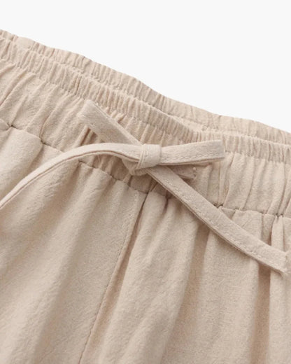 Beige linen trousers by Ilynora, fabric detail highlighting breathable material and natural finish