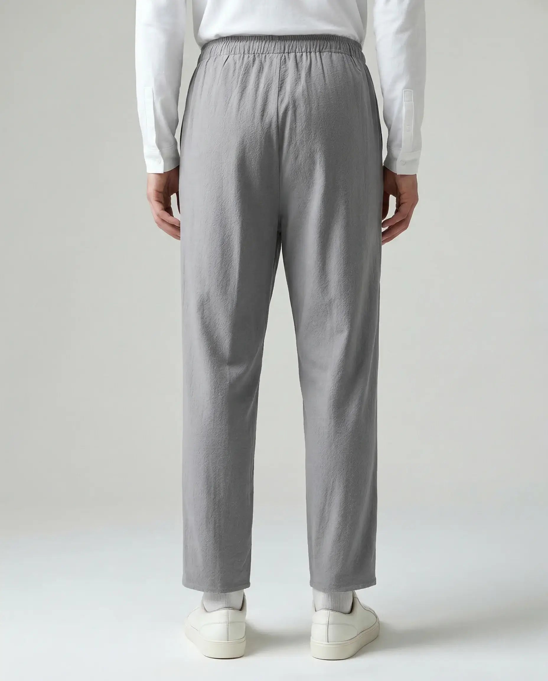 Grey linen drawstring trousers by Ilynora, back view showing elastic waist and relaxed fit