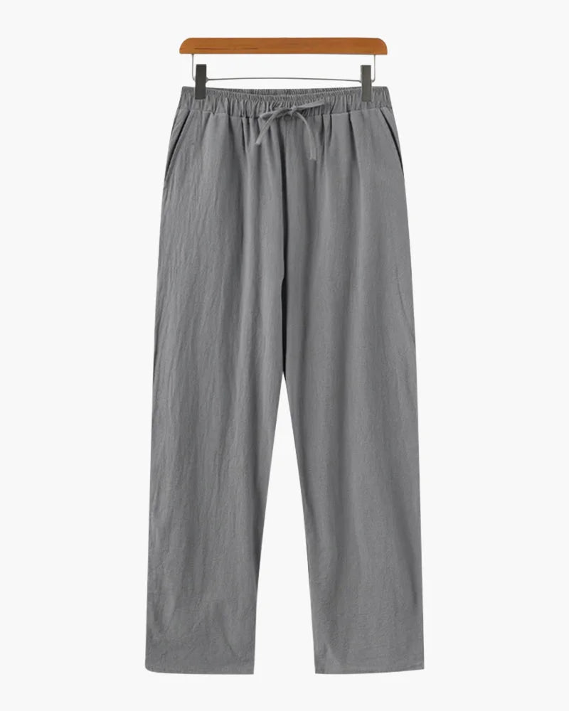 Grey linen trousers by Ilynora, full length view highlighting breathable fabric and clean design
