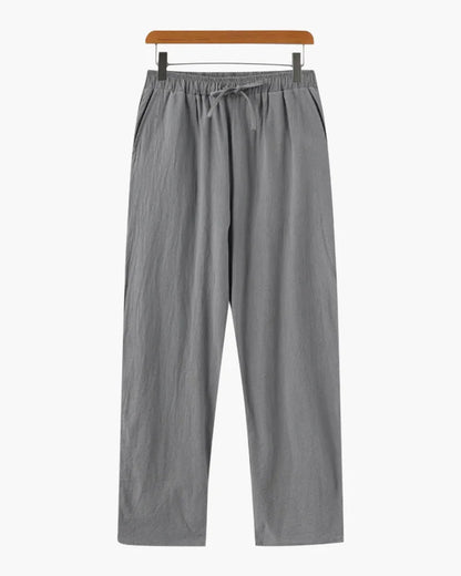 Grey linen trousers by Ilynora, full length view highlighting breathable fabric and clean design