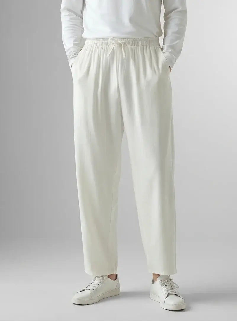 Men's relaxed linen drawstring trousers in white by Ilynora, front view with clean design and airy fabric