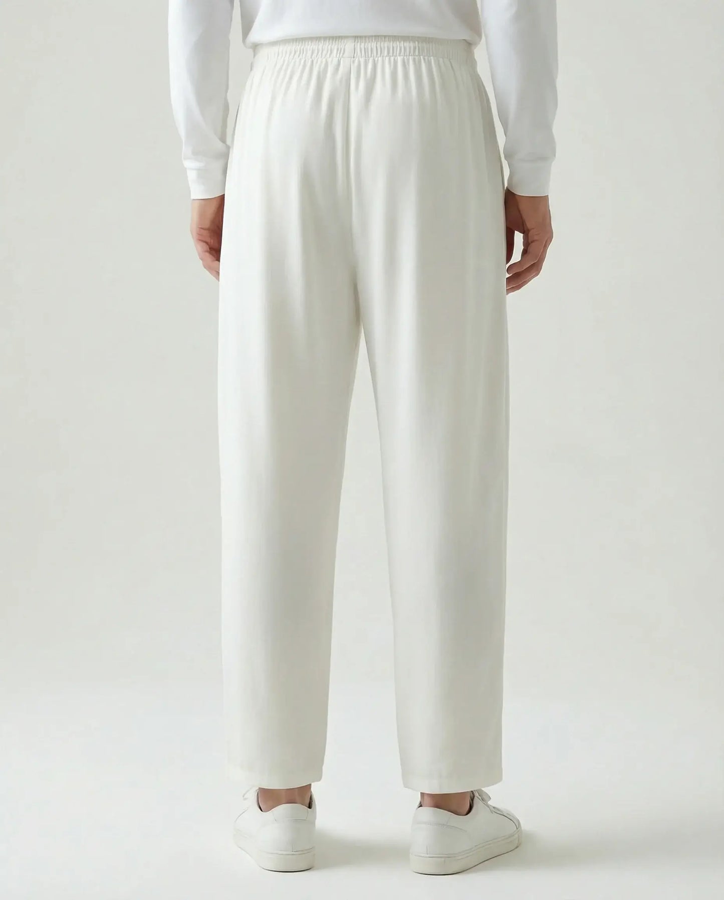 White linen drawstring trousers by Ilynora, back view showing elastic waistband and minimal silhouette