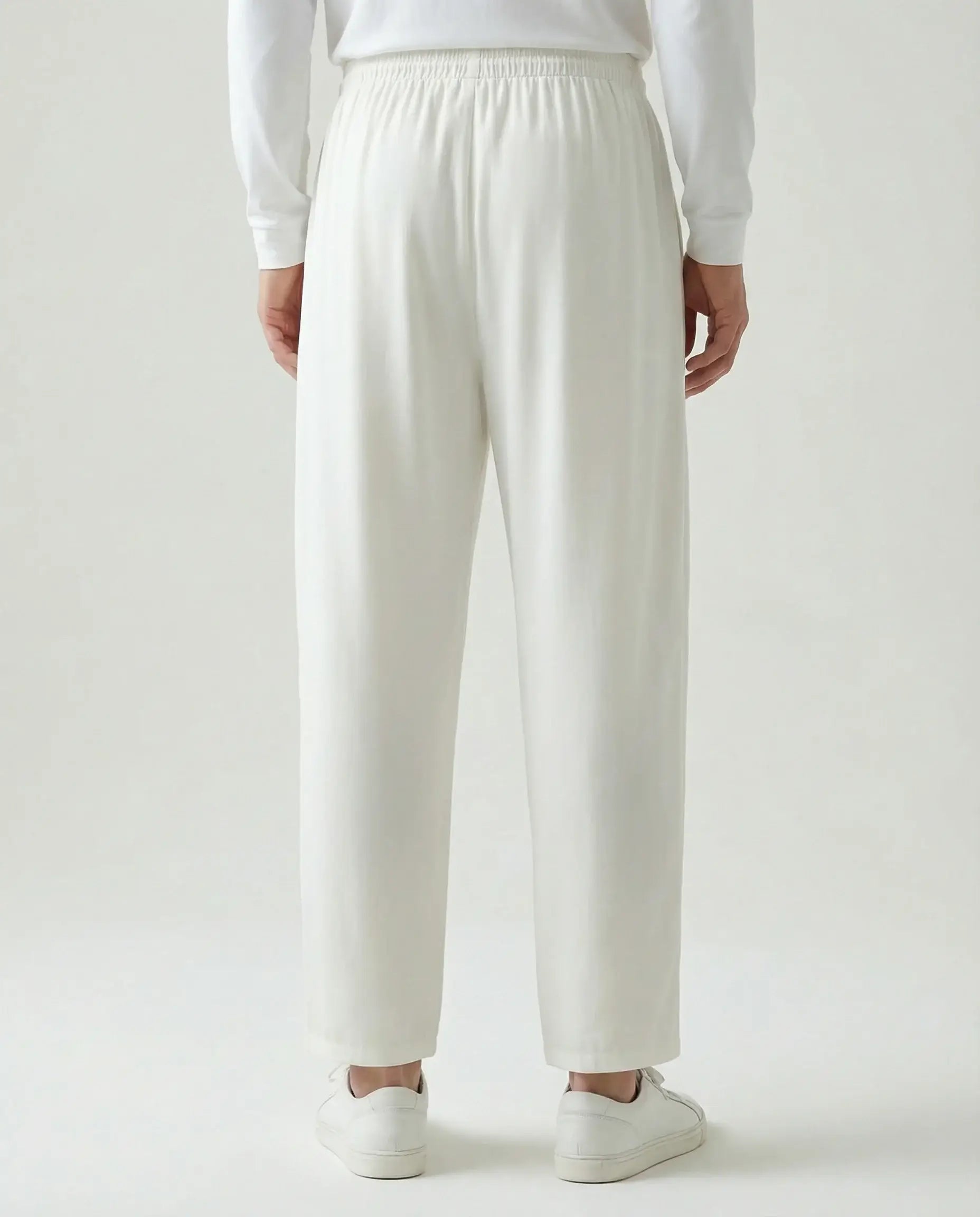 White linen drawstring trousers by Ilynora, back view showing elastic waistband and minimal silhouette