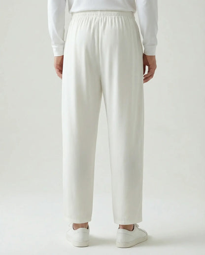 White linen drawstring trousers by Ilynora, back view showing elastic waistband and minimal silhouette