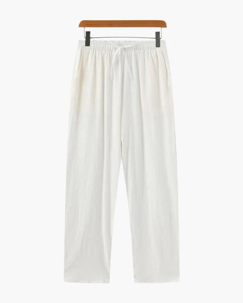 White linen trousers by Ilynora, full body view with relaxed fit and lightweight feel