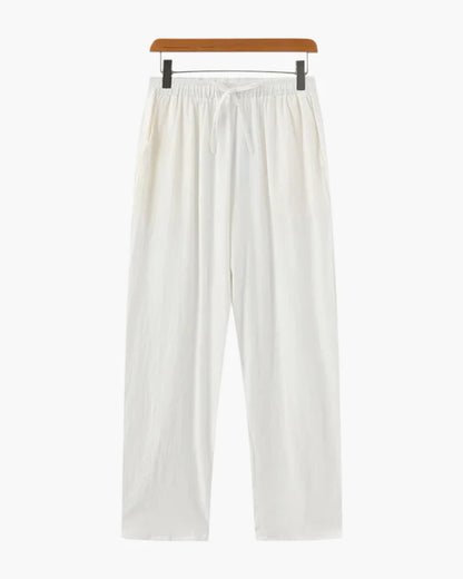 White linen trousers by Ilynora, full body view with relaxed fit and lightweight feel