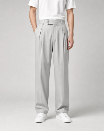 Men's silver wide leg pleated tailored trousers featuring a high waist, flowing drape and modern smart-casual tailoring by ILYNORA