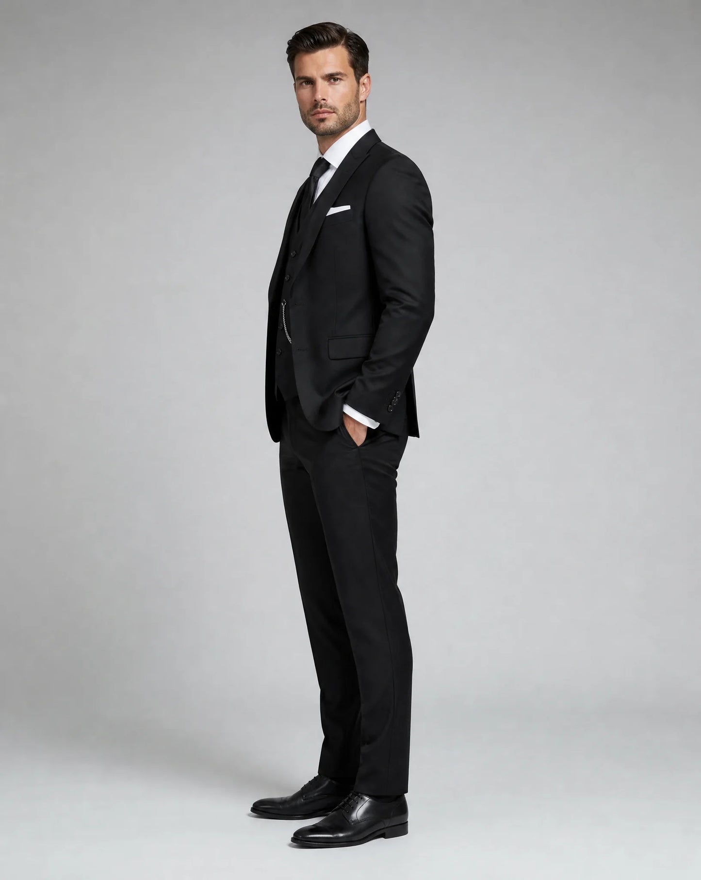Black slim fit three piece wedding suit side view with modern tailored silhouette by ILYNORA