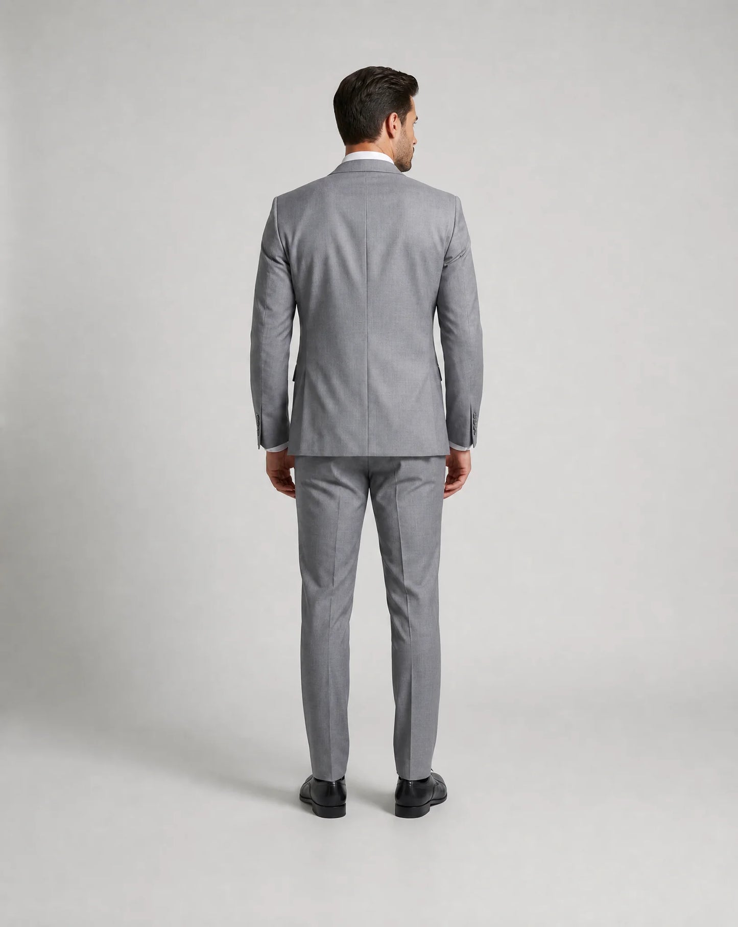 Light grey slim fit three piece suit back view with tailored wedding guest styling by ILYNORA