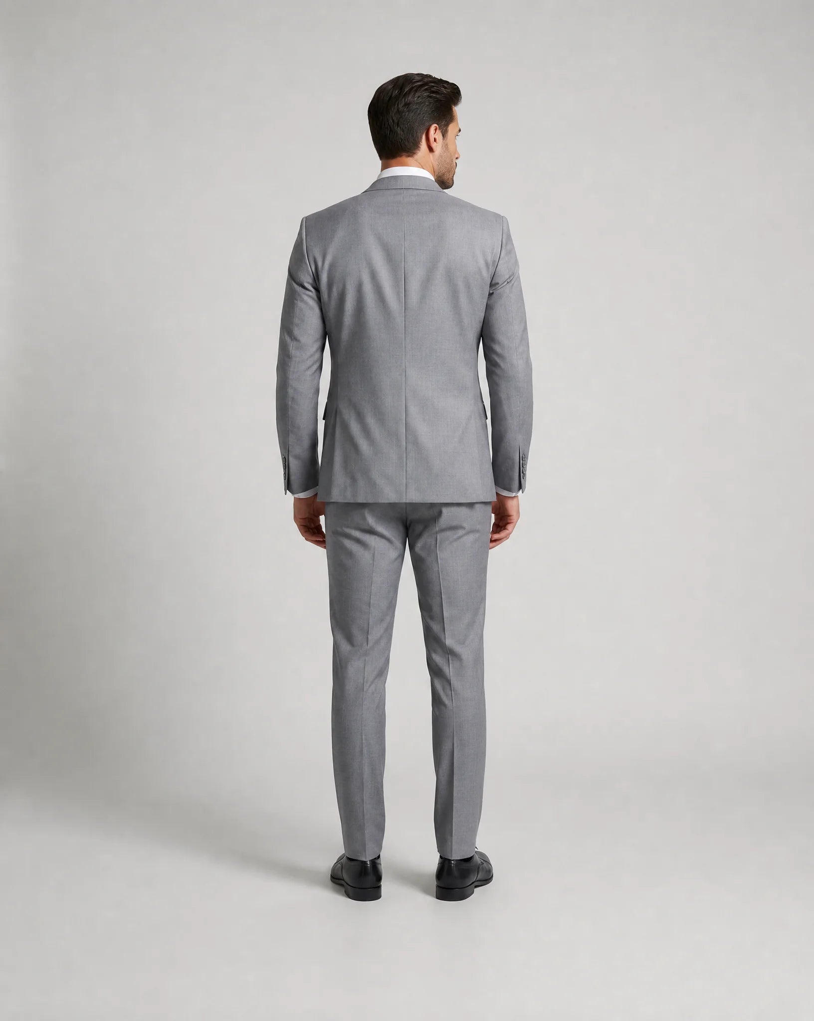 Light grey slim fit three piece suit back view with tailored wedding guest styling by ILYNORA