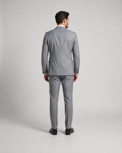 Light grey slim fit three piece suit back view with tailored wedding guest styling by ILYNORA
