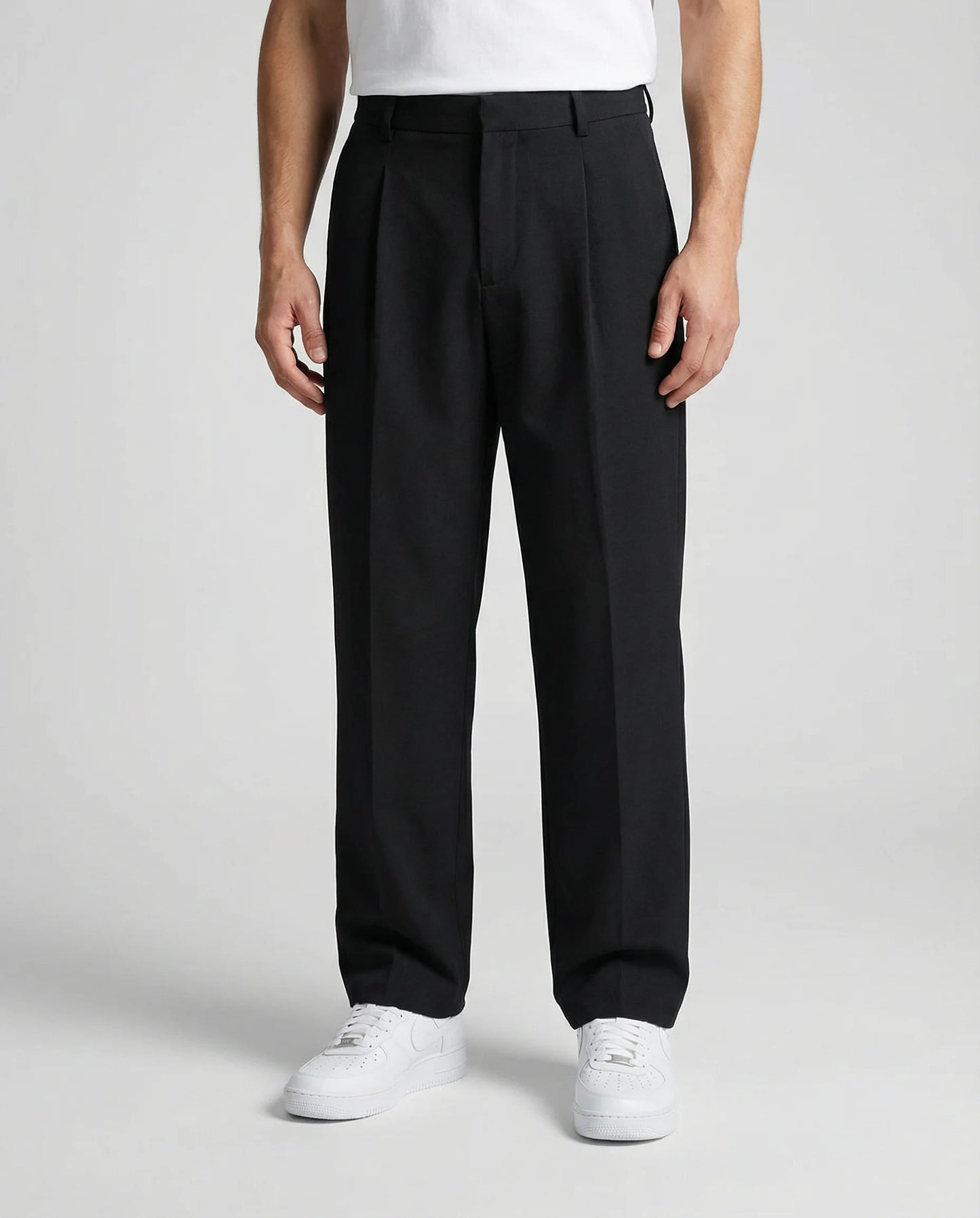 Black tailored wide leg trousers for men by Ilynora, front view with relaxed fit and clean silhouette