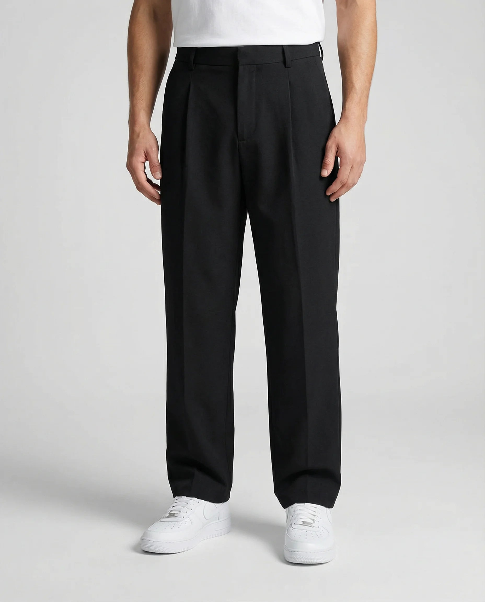 Black tailored wide leg trousers for men by Ilynora, front view with relaxed fit and clean silhouette