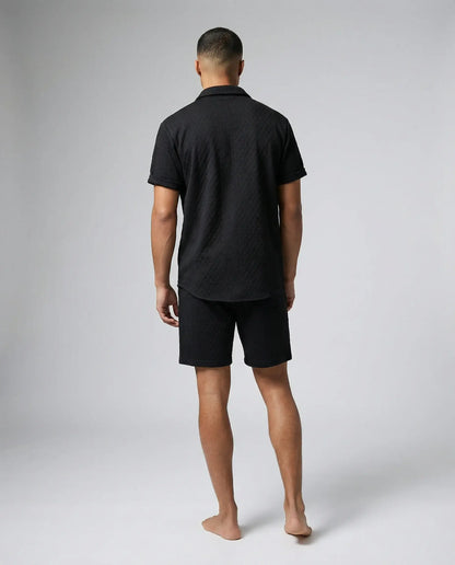 Black shirt and shorts set for men by Ilynora, back view showing relaxed summer fit and minimal design