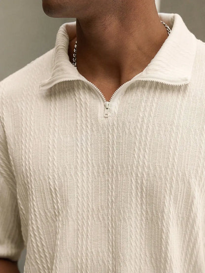 Beige textured polo set by Ilynora, close-up showing zip collar and fabric texture