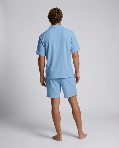 Blue zip polo and shorts set by Ilynora, back view highlighting breathable fabric and coordinated design