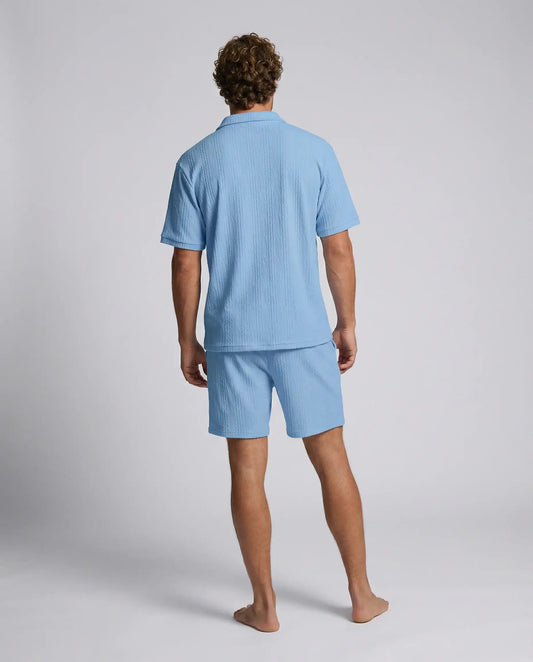 Blue zip polo and shorts set by Ilynora, back view highlighting breathable fabric and coordinated design