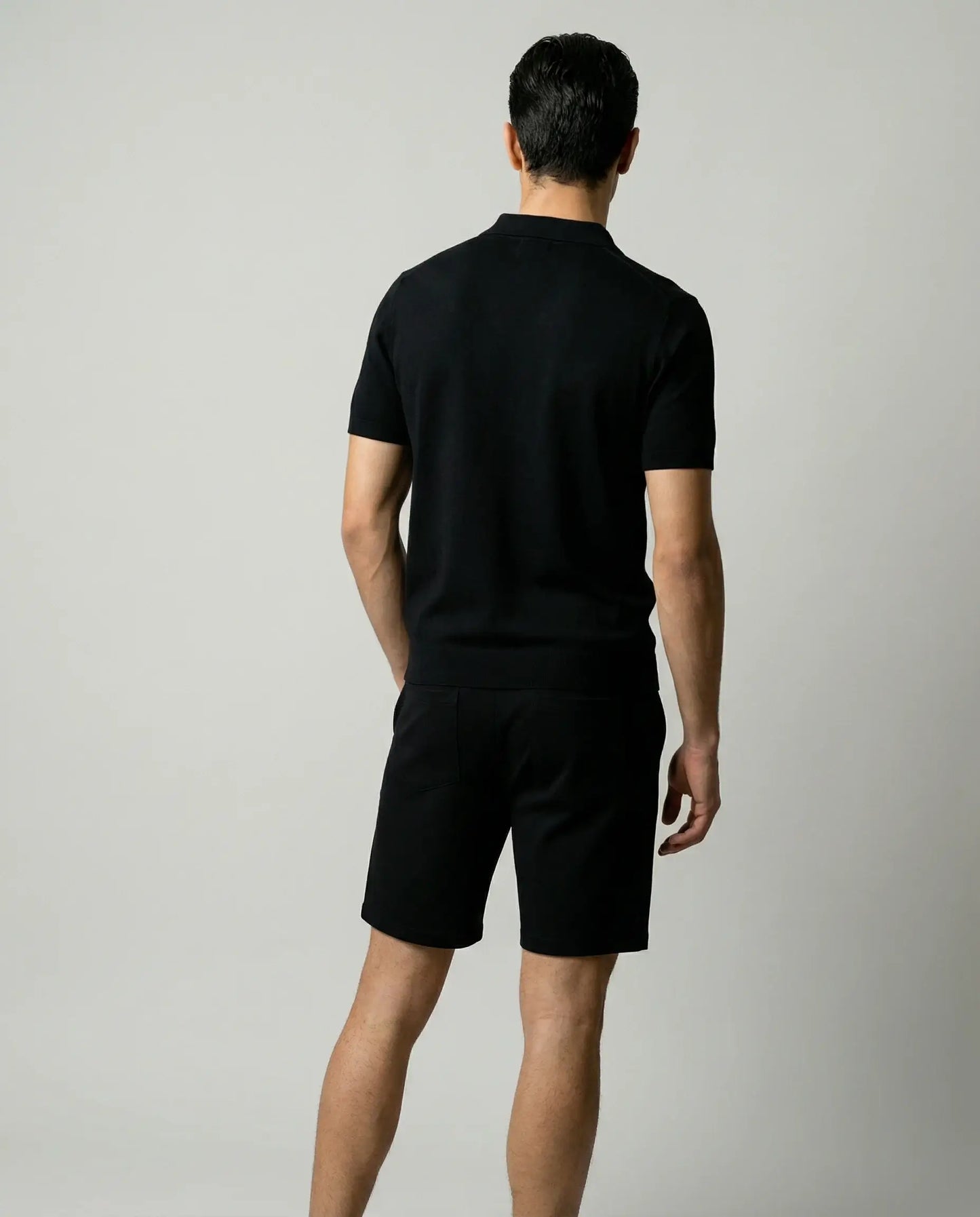 Black zip polo and shorts set for men by Ilynora, back view of matching outfit with relaxed fit