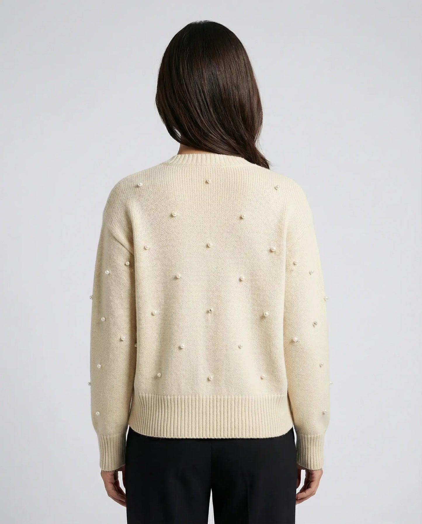 Cream cardigan by Ilynora, back view with soft knit texture and relaxed silhouette