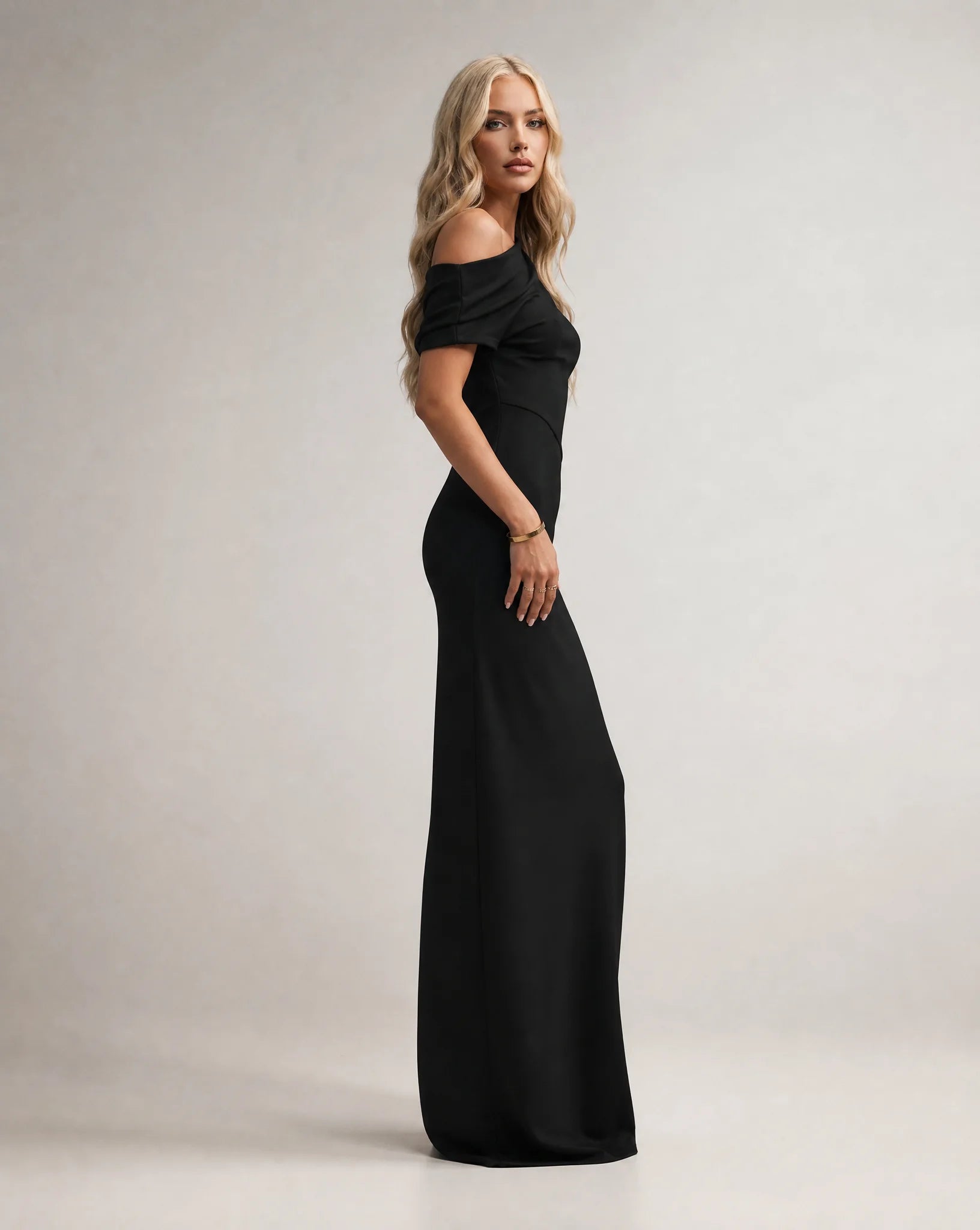 Black one shoulder maxi dress for women by Ilynora, side view highlighting the sleek fit and flowing design