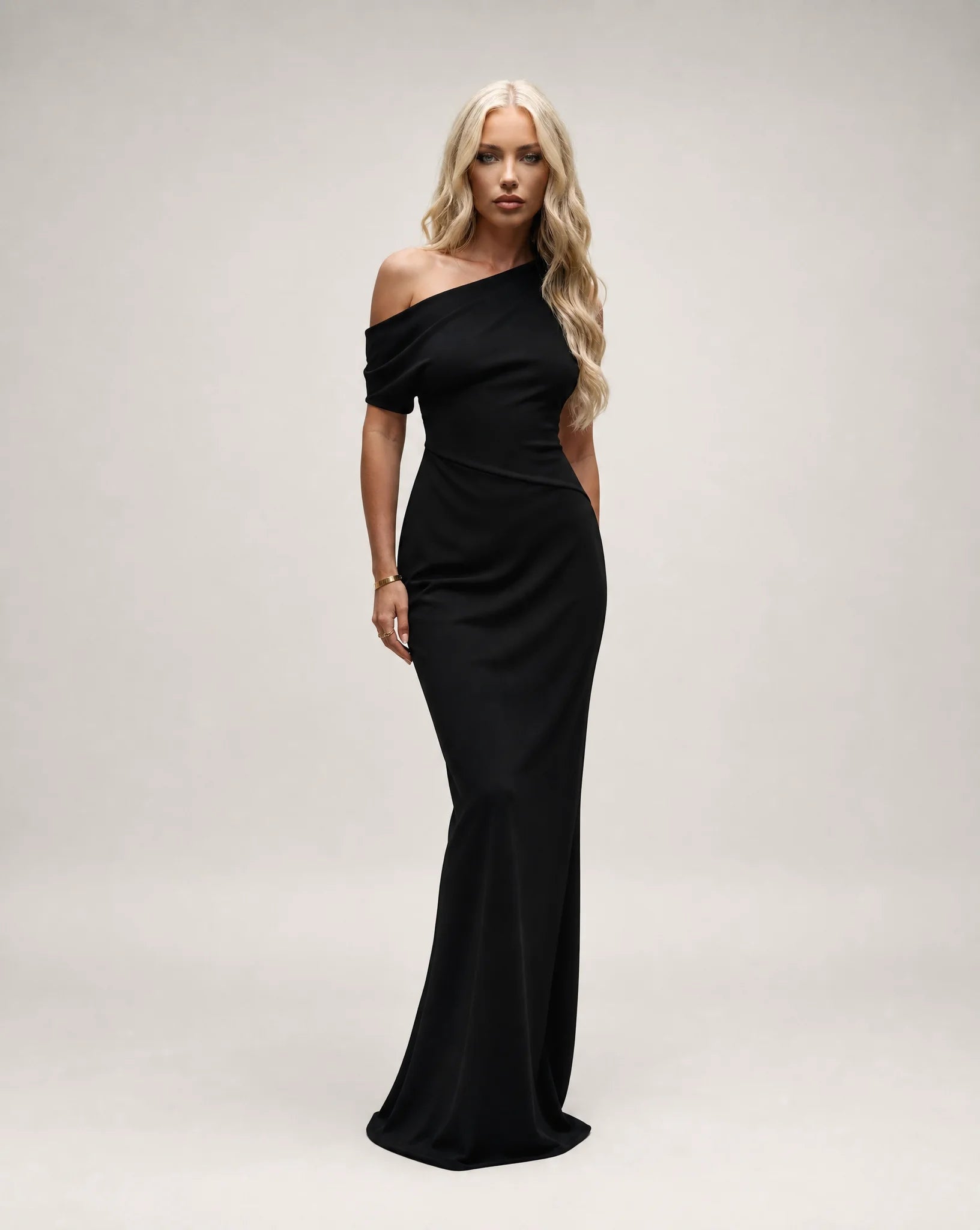 Black one shoulder maxi dress for women by Ilynora, front view with elegant silhouette and asymmetrical neckline