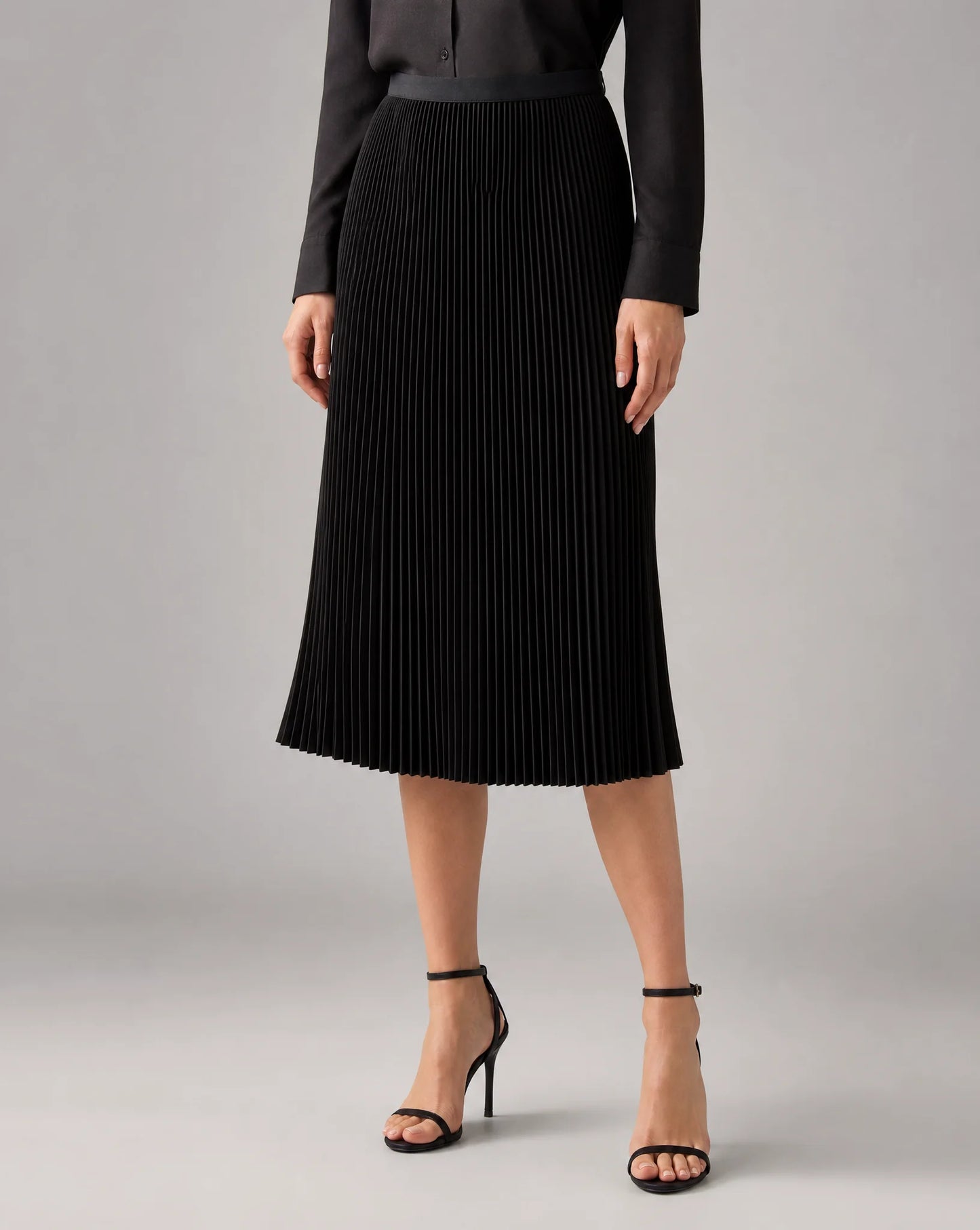 Black pleated midi skirt for women by Ilynora, front view with timeless design and flowing silhouette