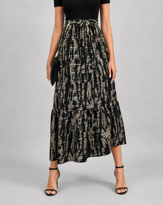 Black and gold printed A line midaxi dress for women by Ilynora, front view with flowing silhouette and elegant print