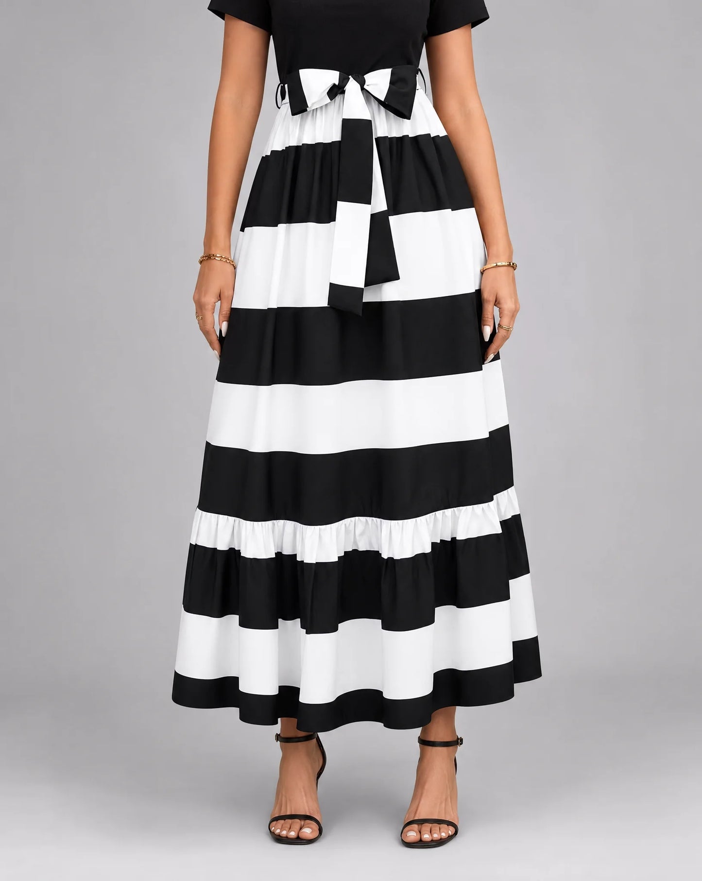 Black striped A line midaxi dress for women by Ilynora, front view with flowing silhouette and bold pattern