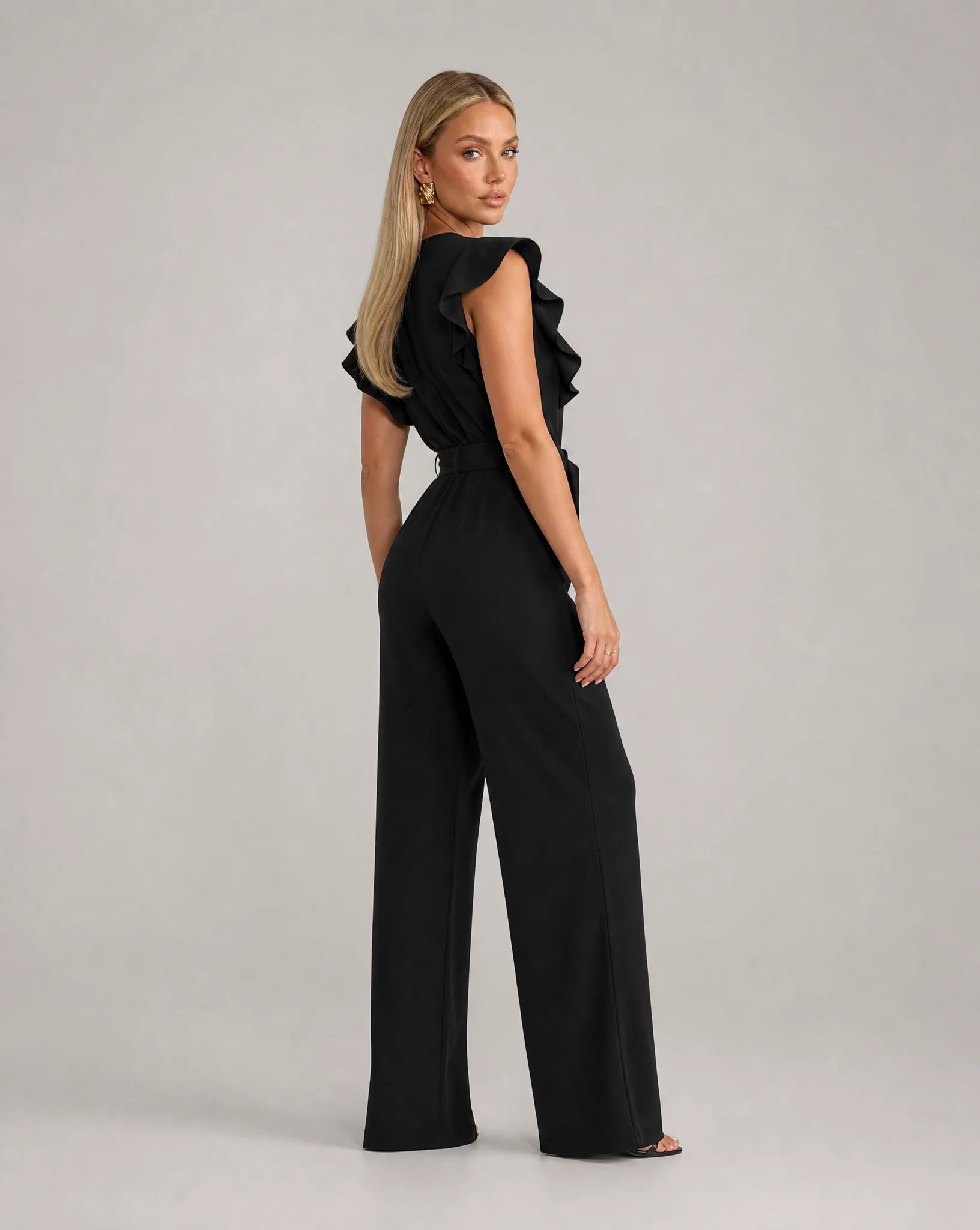 Black ruffle sleeve jumpsuit for women by Ilynora, back view showcasing the elegant fit and flowing design