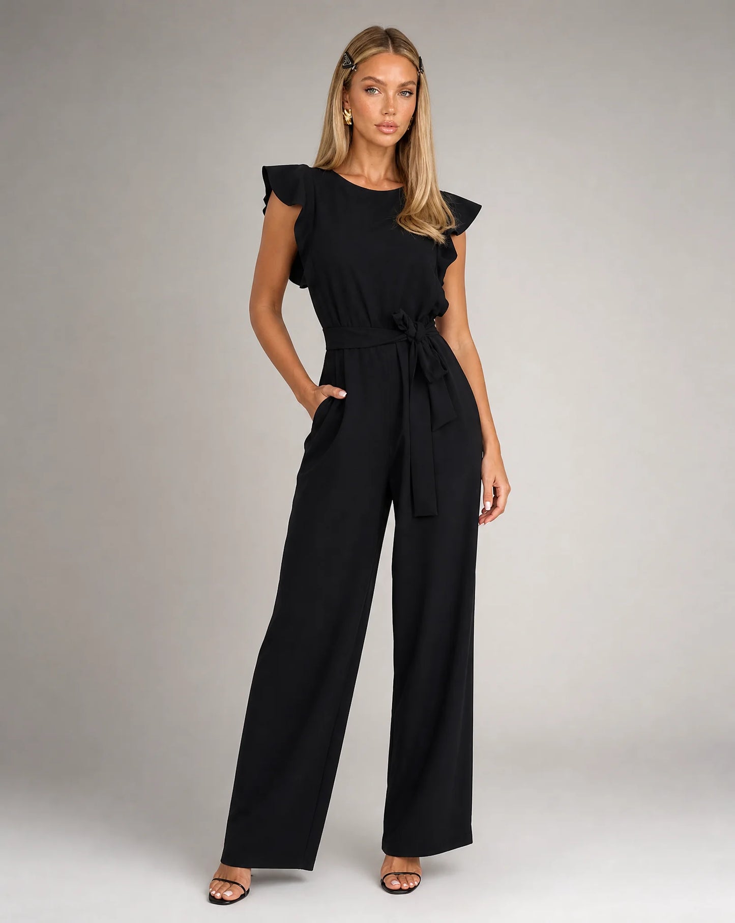 Black ruffle sleeve jumpsuit for women by Ilynora, front view with belted waist and wide leg silhouette
