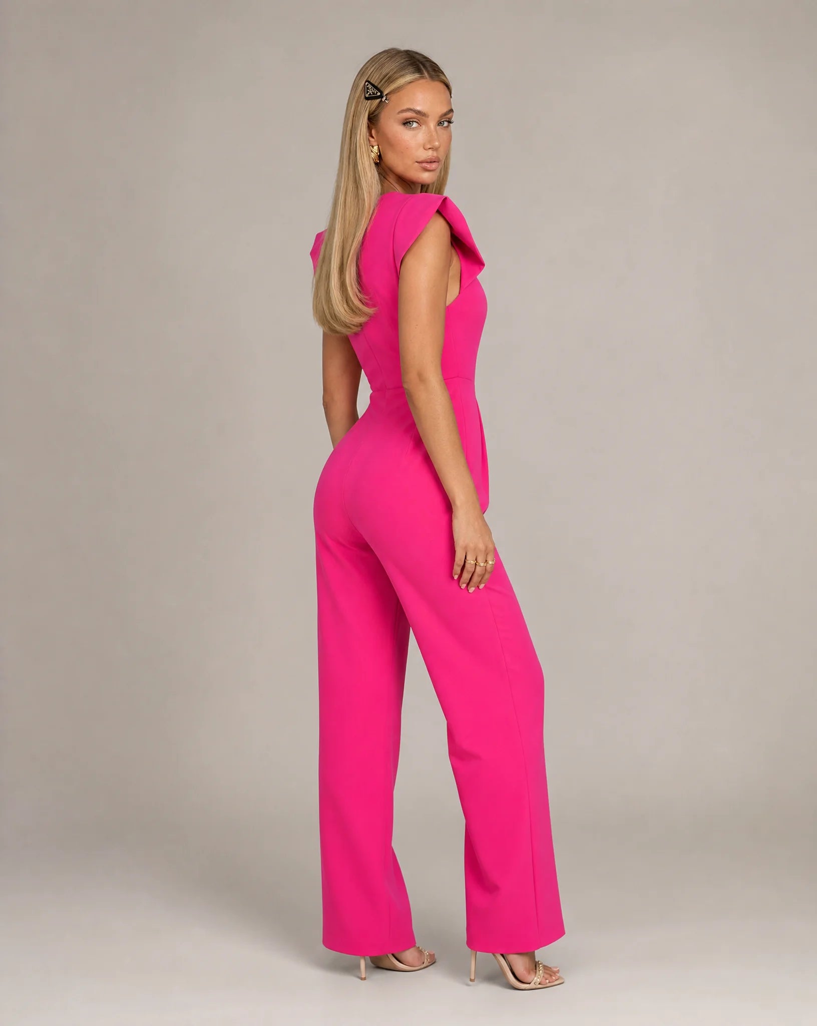 Pink ruffle sleeve jumpsuit for women by Ilynora, back view showcasing the flattering fit and soft fabric