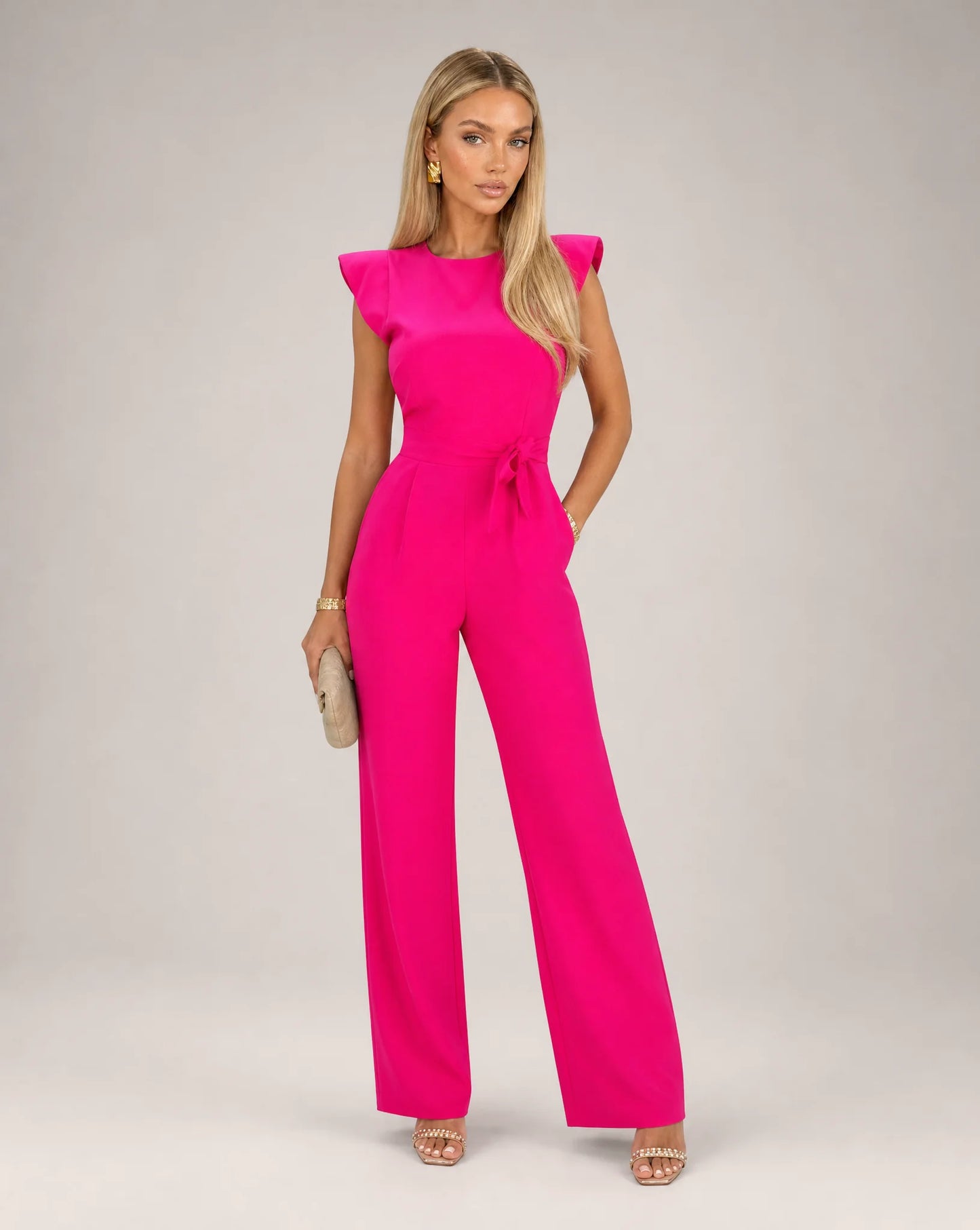 Pink ruffle sleeve jumpsuit for women by Ilynora, front view with belted waist and elegant wide leg fit