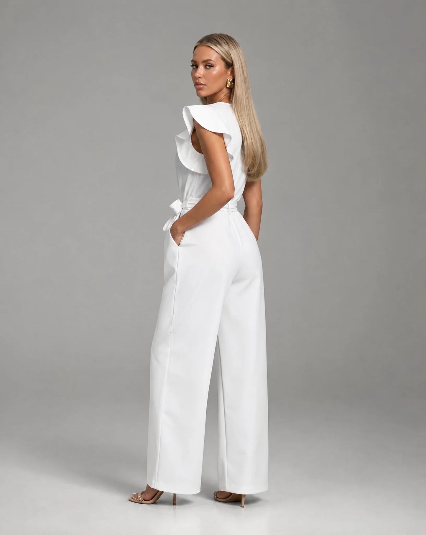 White ruffle sleeve jumpsuit for women by Ilynora, back view highlighting the tailored fit and elegant design