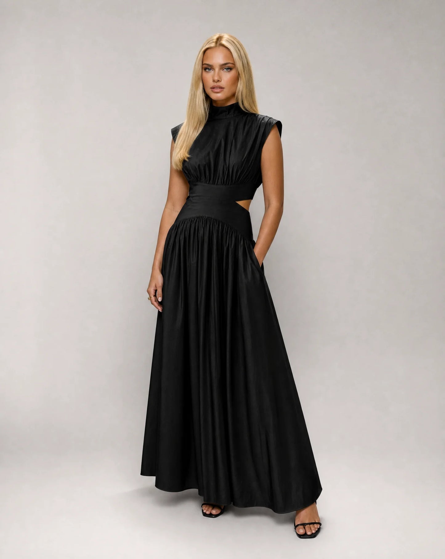 Black sleeveless cut out maxi dress for women by Ilynora, front view with elegant drape and refined silhouette