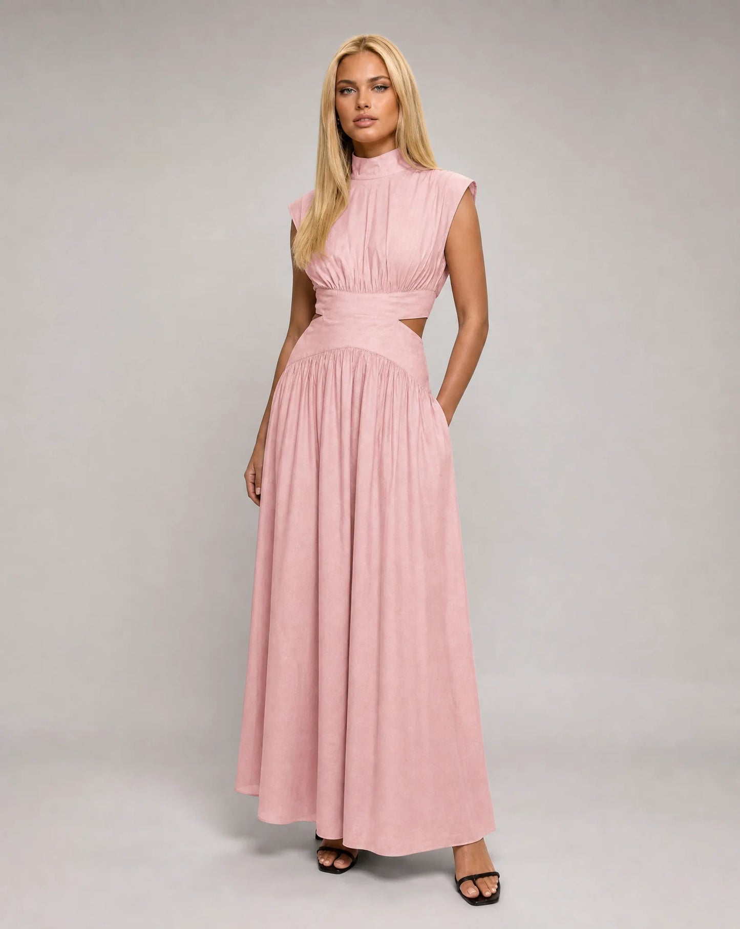 Pink sleeveless cut out maxi dress for women by Ilynora, front view with flowing skirt and feminine silhouette