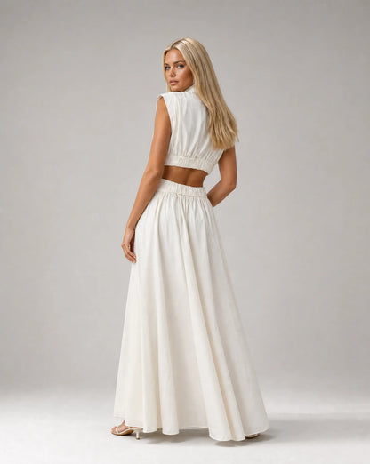 White sleeveless cut out maxi dress for women by Ilynora, side view highlighting the waist detail and flowing fit