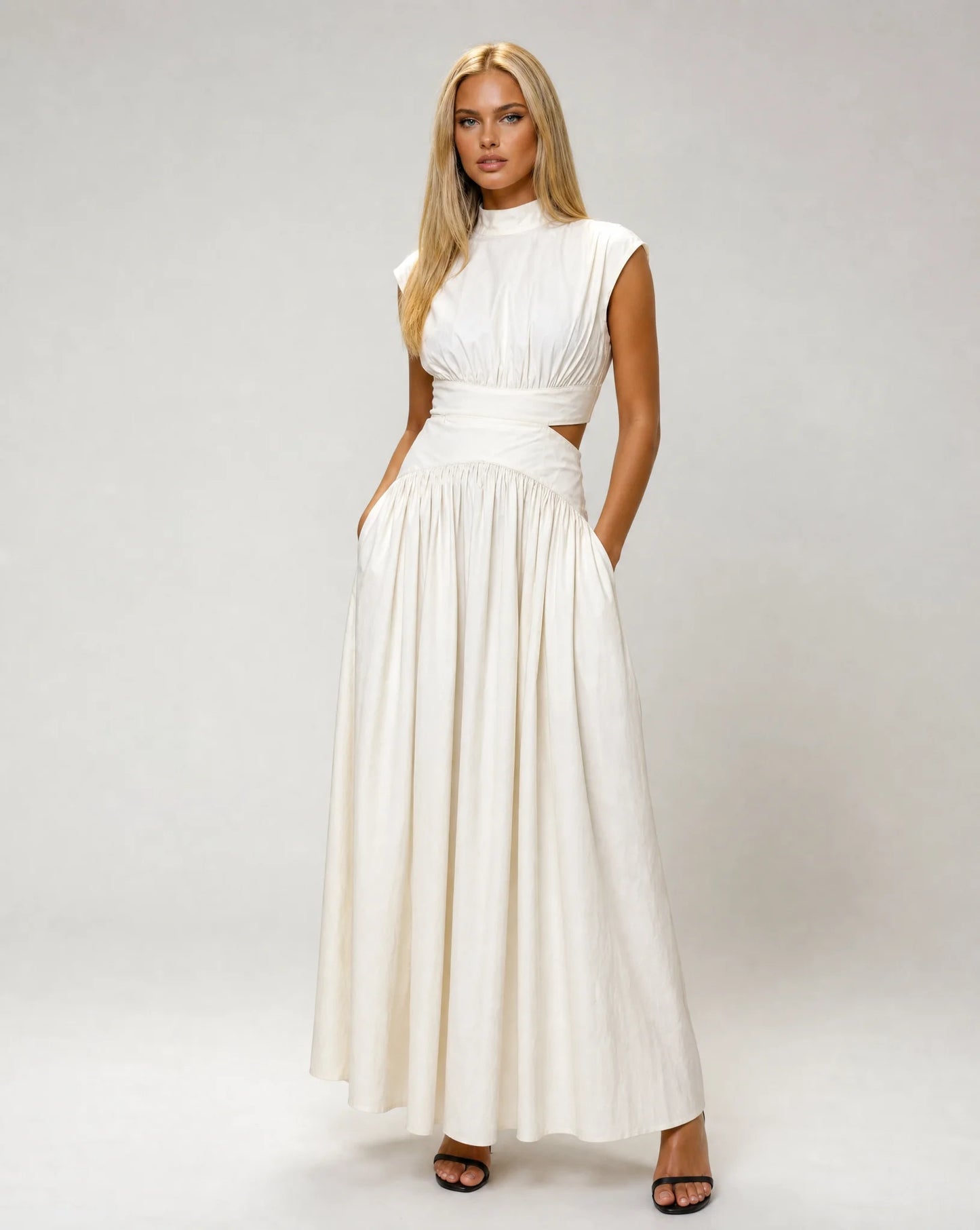 White sleeveless cut out maxi dress for women by Ilynora, front view with elegant silhouette and flowing skirt