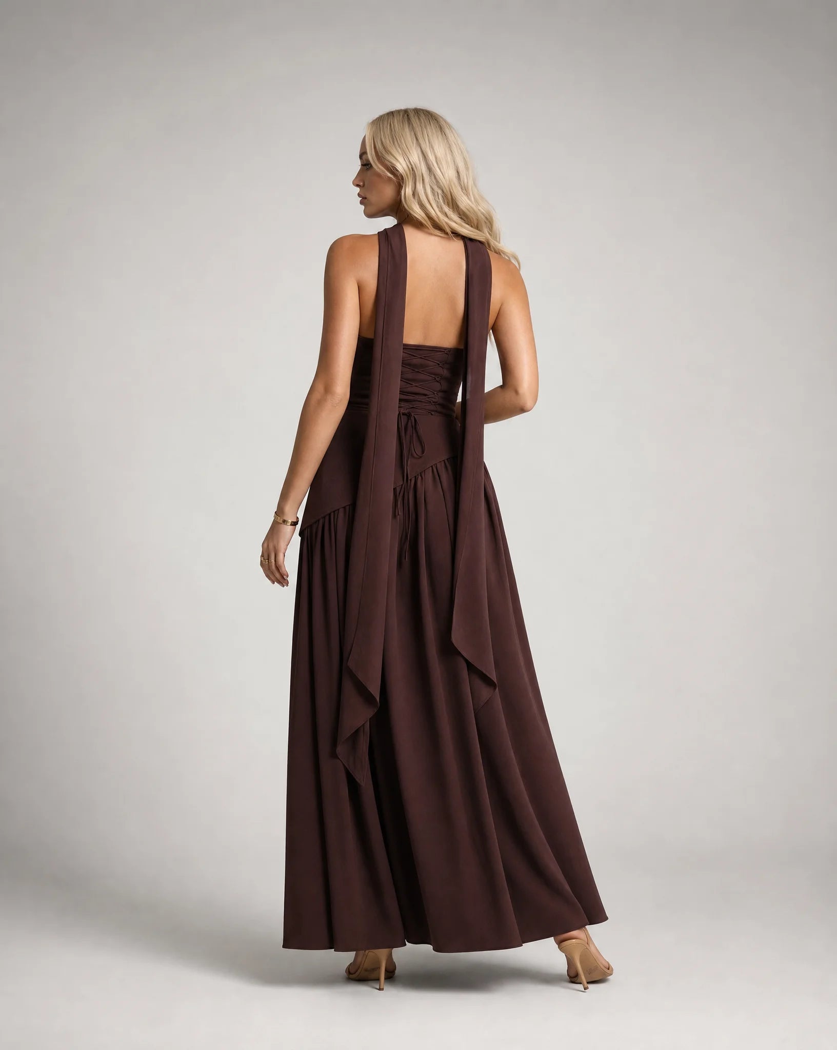 Brown strapless maxi dress for women by Ilynora, back view showcasing the flowing silhouette and scarf detail