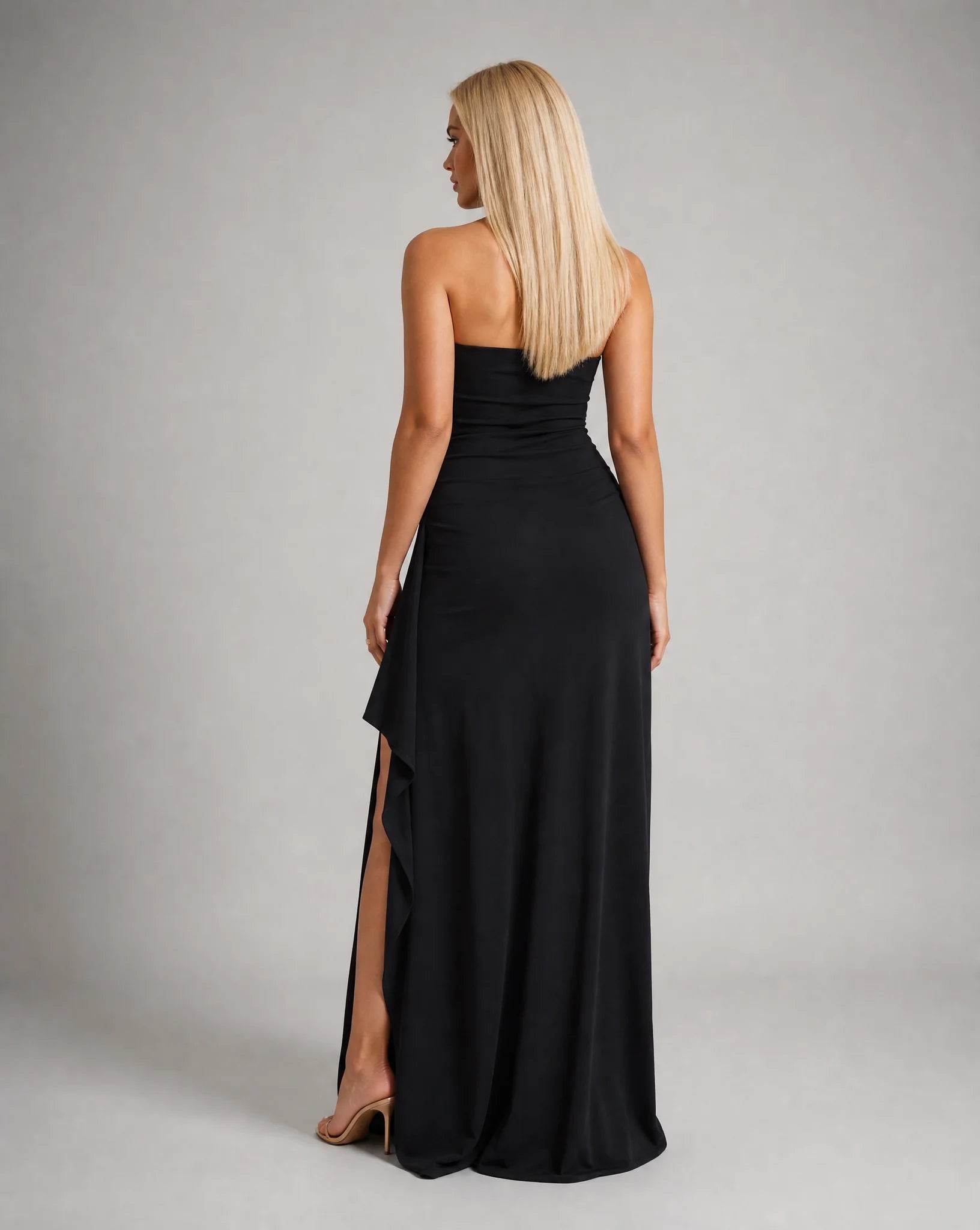 Black strapless ruched maxi dress for women by Ilynora, back view showcasing the elegant silhouette and sleek fit