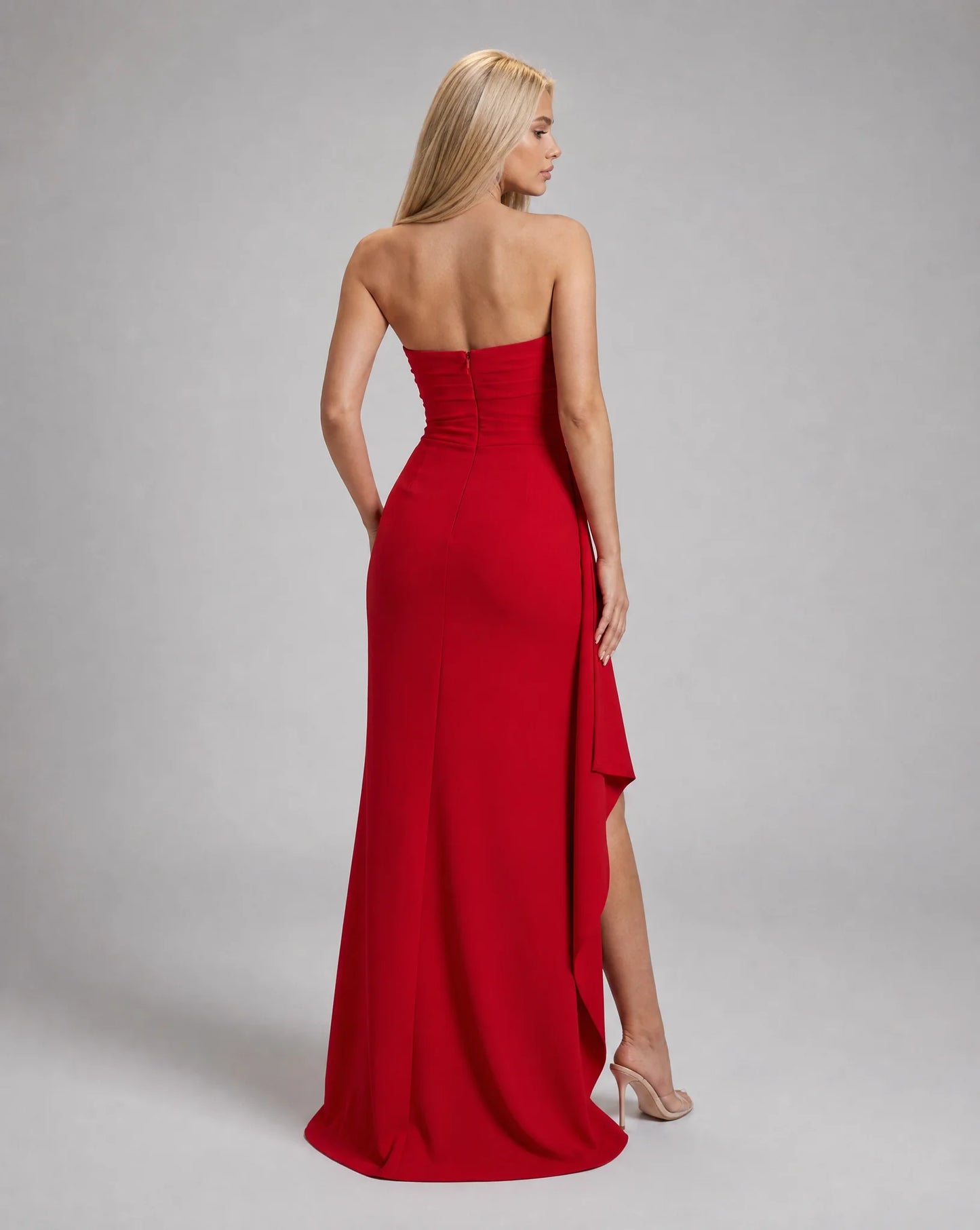 Red strapless ruched maxi dress for women by Ilynora, back view highlighting the flowing silhouette and open back