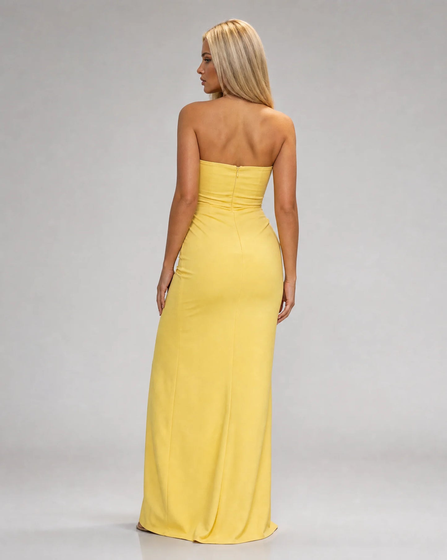 Yellow strapless ruched maxi dress for women by Ilynora, back view showcasing the flowing fit and sleek design