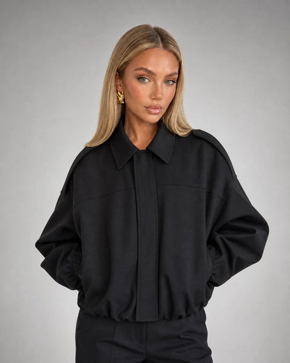 Black suede bomber jacket for women by Ilynora, front view with oversized fit and minimalist style