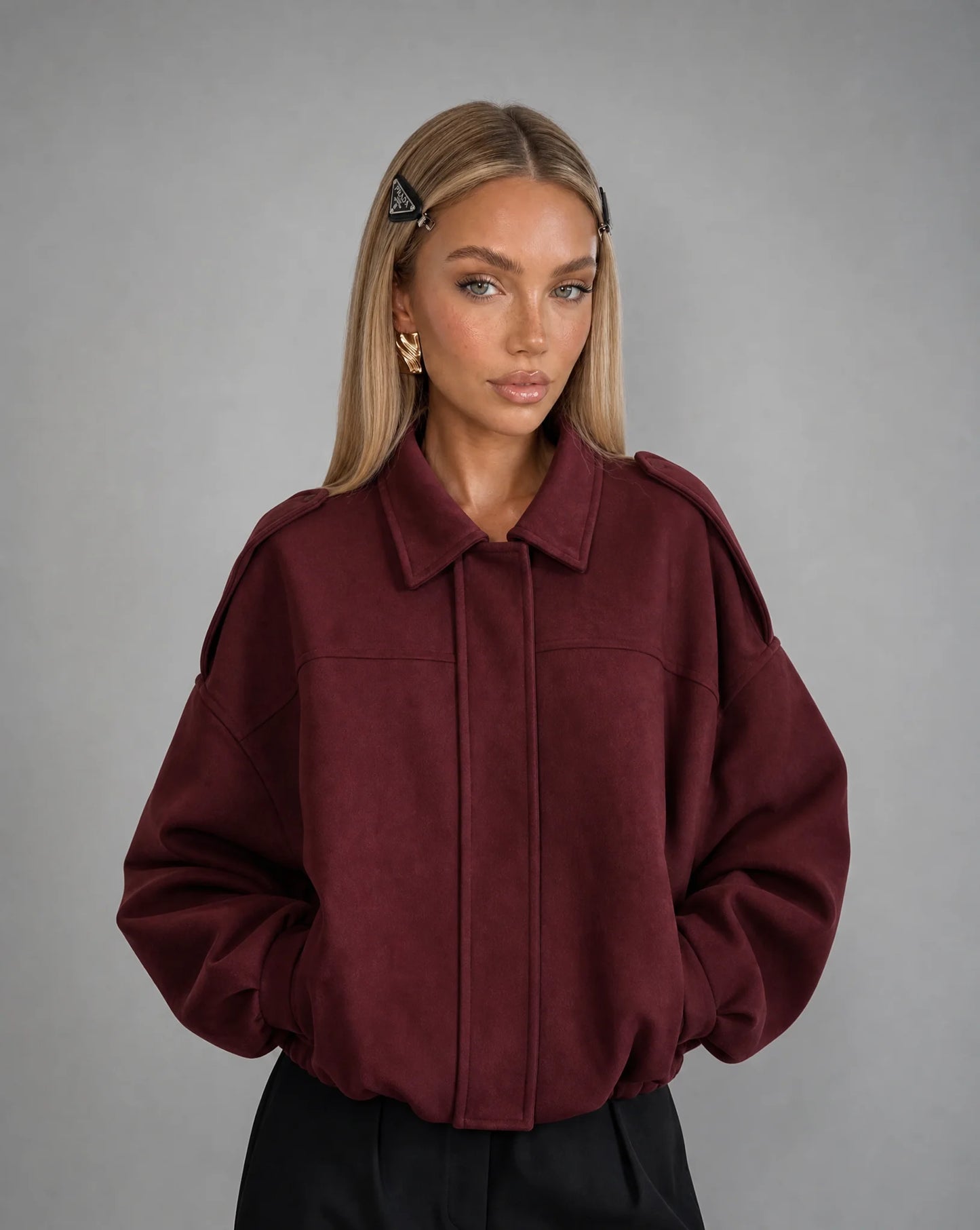 Burgundy suede bomber jacket for women by Ilynora, front view with soft texture and relaxed silhouette