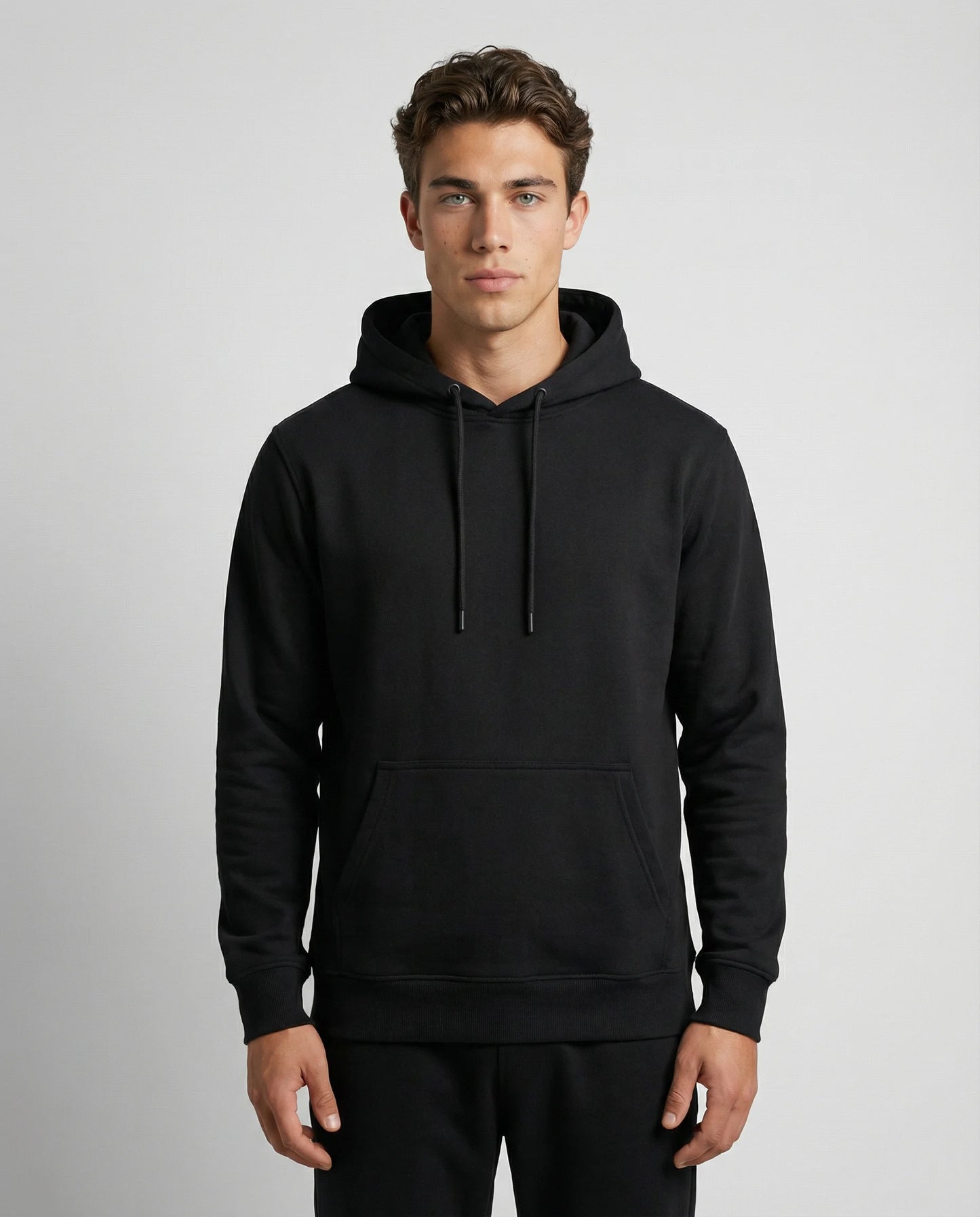 Black unisex hoodie by Ilynora, front view with clean minimal design and regular fit