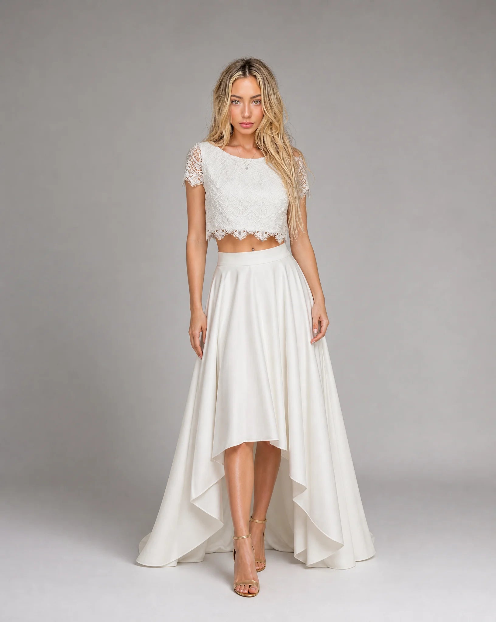 Front view of women's white bohemian lace wedding dress featuring a two-piece design, high low skirt and romantic bridal styling by ILYNORA