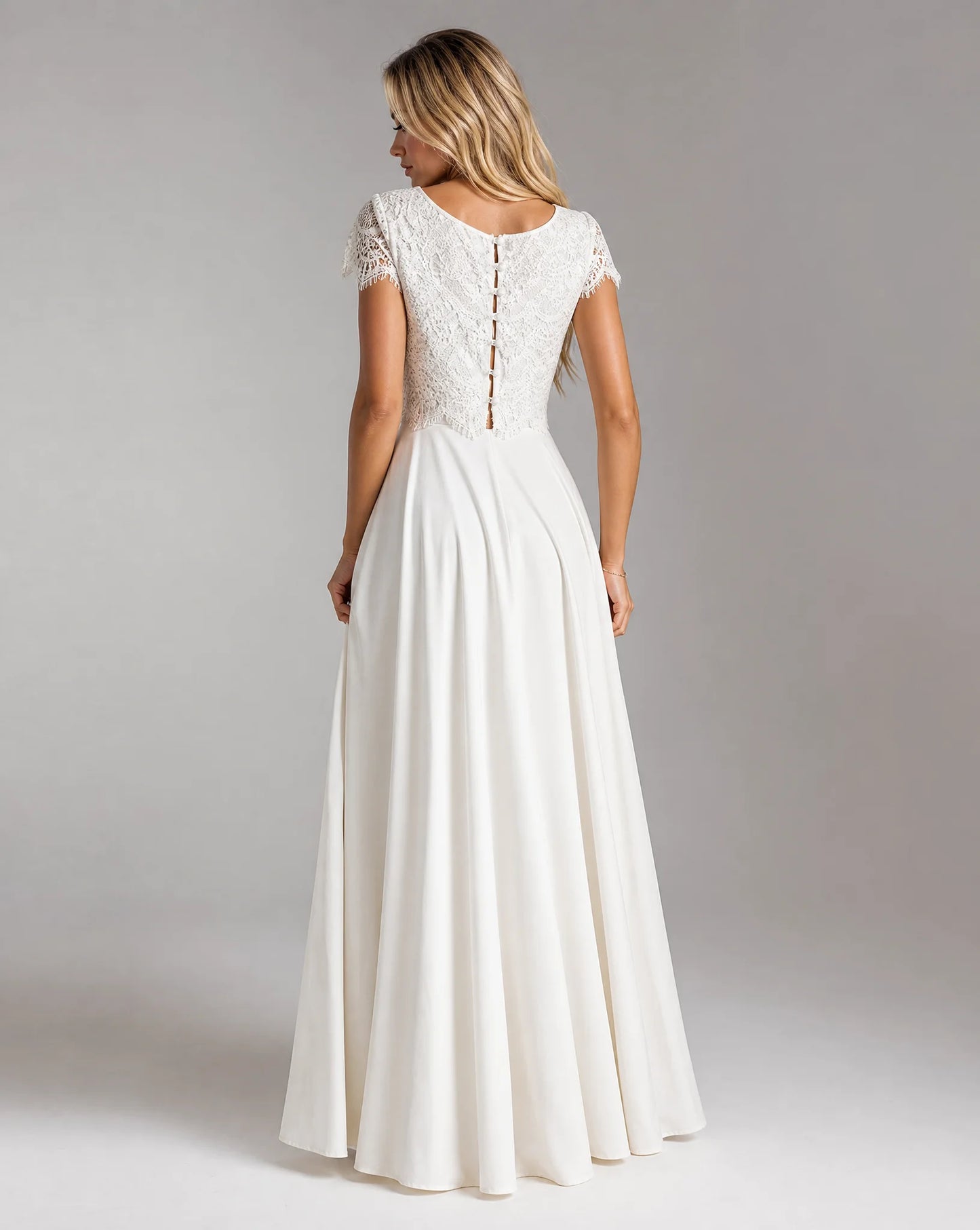 Back view of women's white bohemian lace high low wedding dress with elegant two-piece design and flowing bridal skirt by ILYNORA