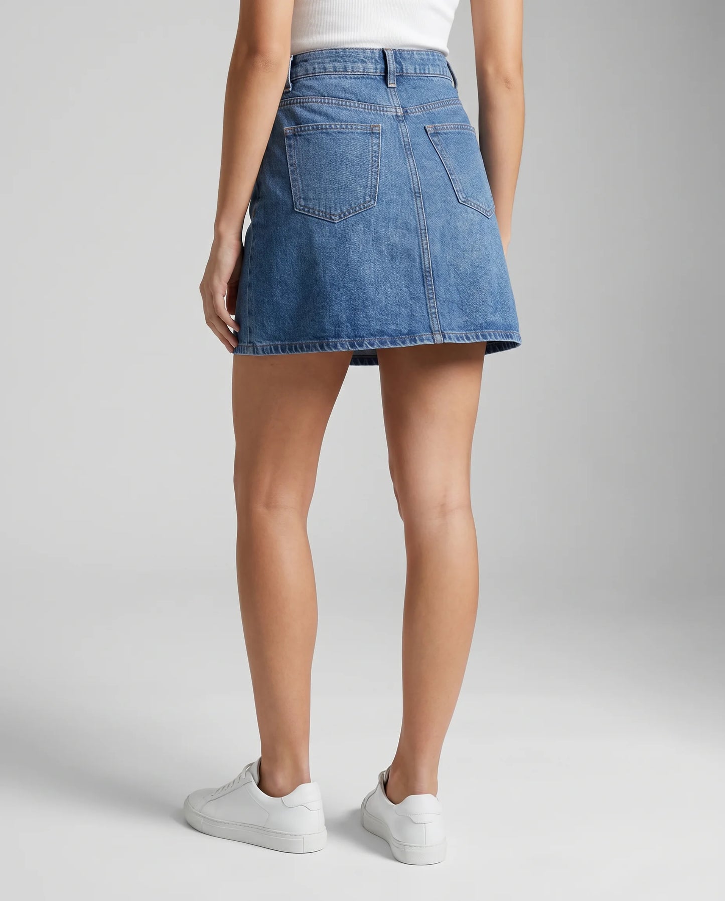 Blue denim A-line mini skirt back view with classic high waist design and timeless casual look by ILYNORA