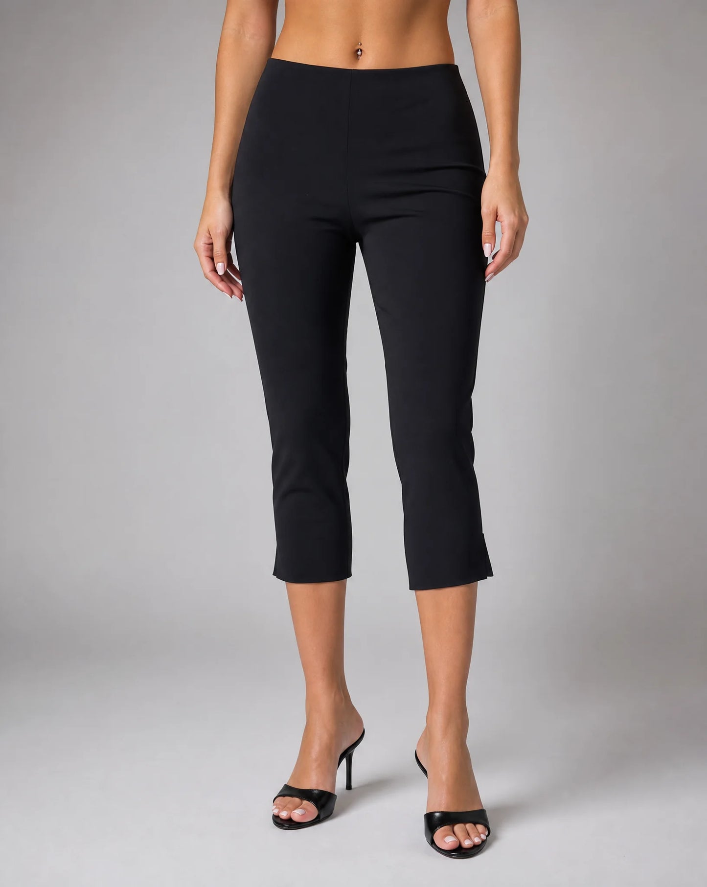 Women's black tailored capri pants with cropped slim fit, side split hem and mid rise waist by ILYNORA