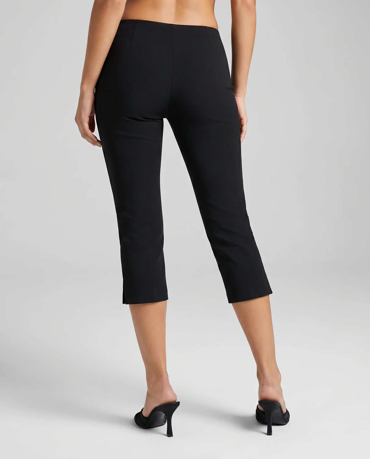 Women's black tailored capri trousers with cropped length, comfortable stretch fabric and back view by ILYNORA